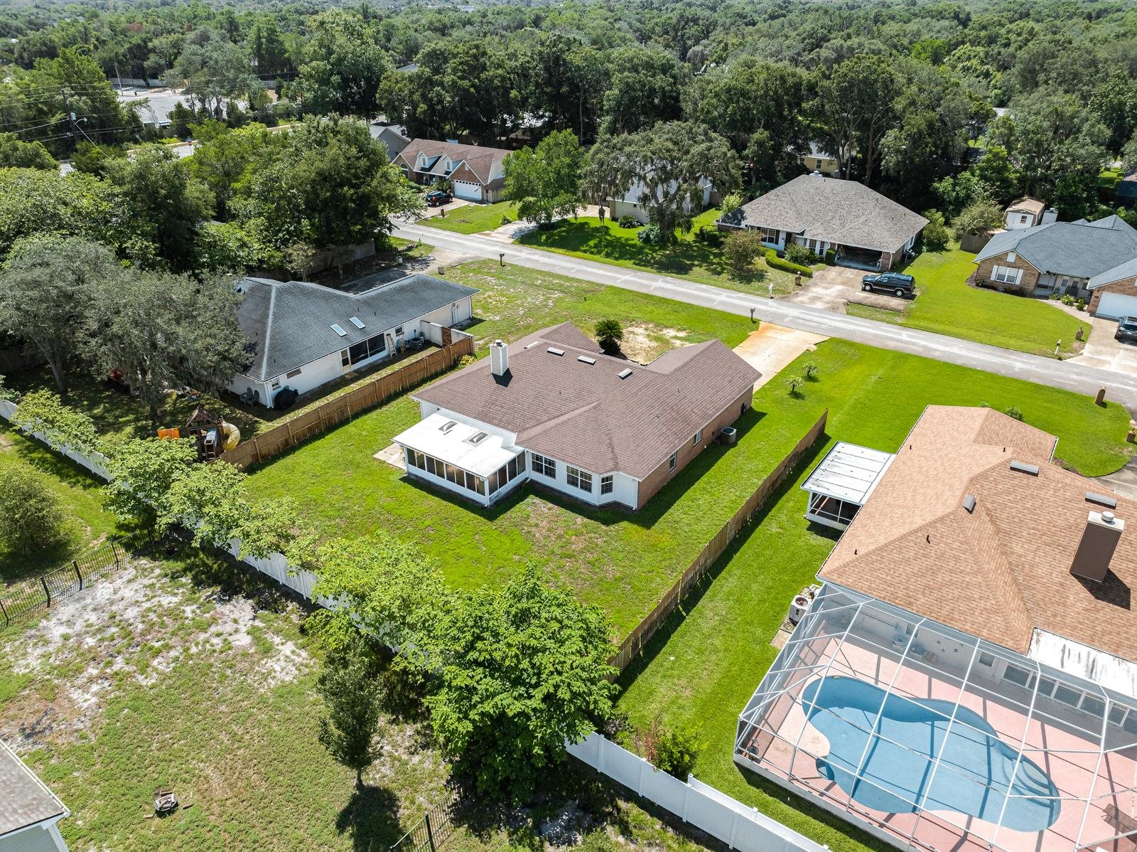 512 Moultrie Wells Road St. Augustine, FL 32086 - Photo 47 of 51 an aerial view of a house with a garden and swimming pool