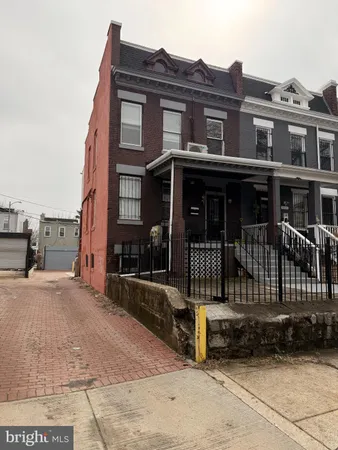 a view of a brick house with large windows