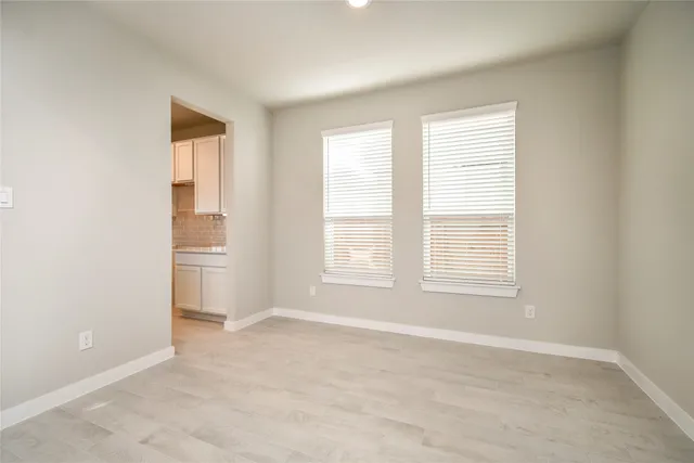 an empty room with a empty space and windows