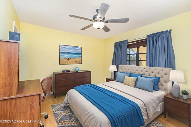 a bedroom with a bed and a dresser with the potted plant