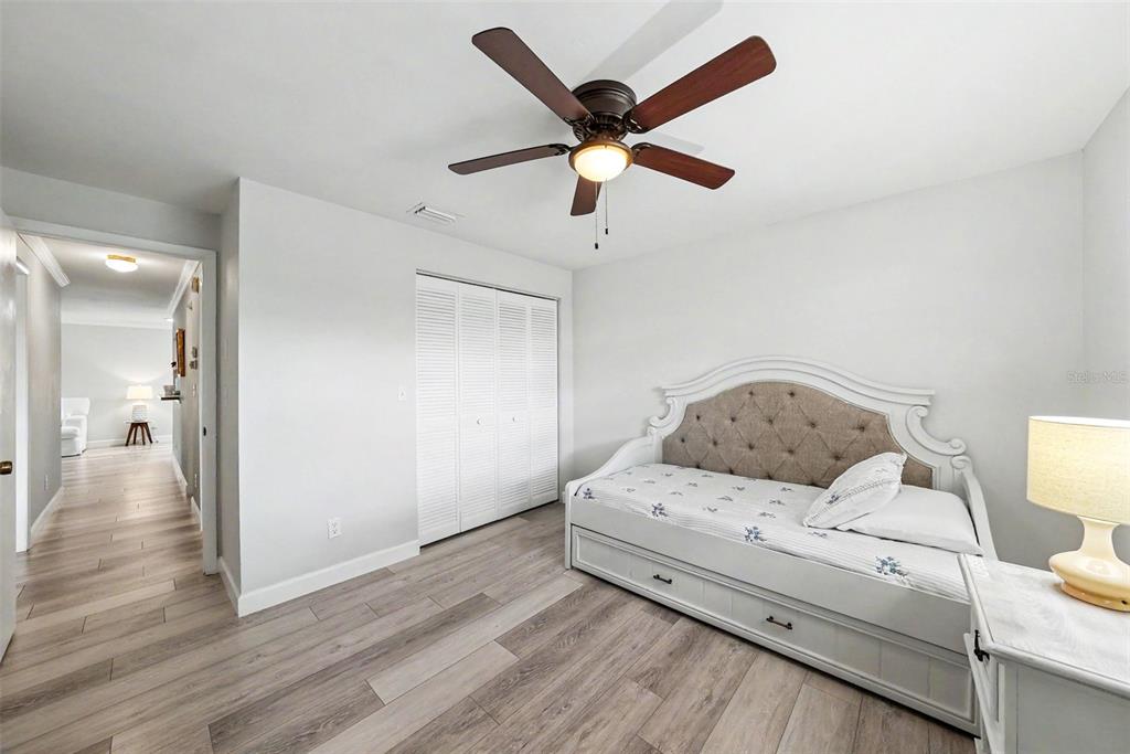 9204 Golf View Drive New Port Richey, FL 34655 - Photo 20 of 33 a bedroom with a bed and a ceiling fan