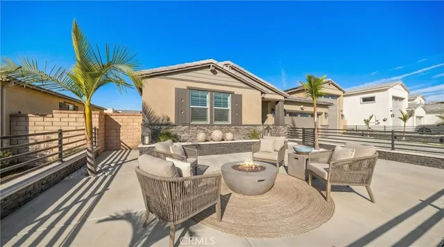 a view of a patio with couches chairs and potted plants