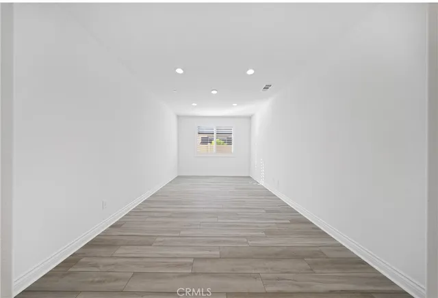 a large kitchen with stainless steel appliances granite countertop a sink a stove and a wooden floors