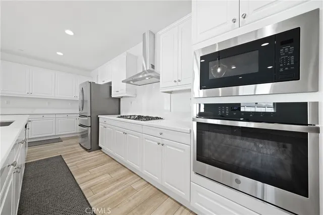 a view of a dining room with furniture wooden floor and chandelier