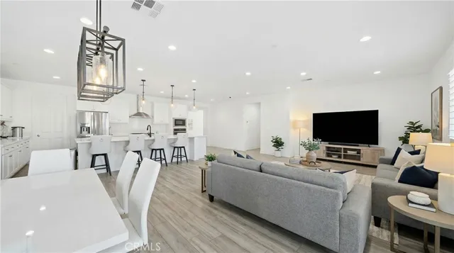 a spacious bedroom with a bed and a flat screen television