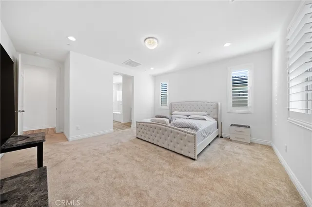 a spacious bathroom with a sink a mirror a vanity and a toilet