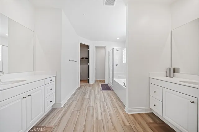 a view of a bedroom with a bed and lamp