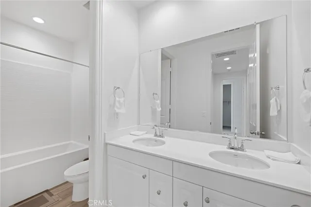 a spacious bathroom with a sink and a mirror