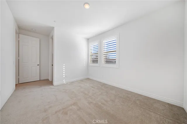 a view of a backyard with couches plants and wooden fence