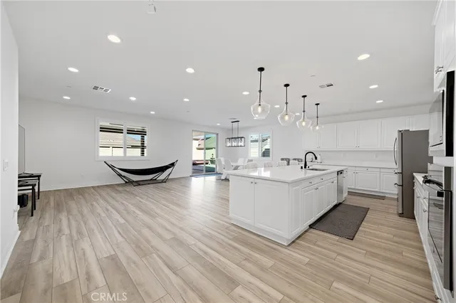 a living room with kitchen island furniture and a wooden floor