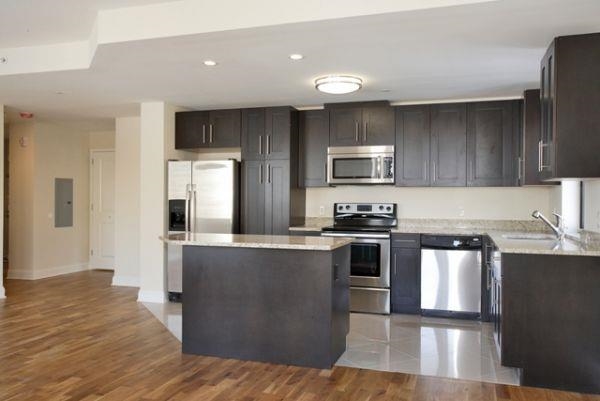 29 1st Street, Unit 607 Hackensack, NJ 07601 - Photo 3 of 13 a kitchen with stainless steel appliances granite countertop a stove a sink and a refrigerator