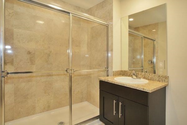 29 1st Street, Unit 607 Hackensack, NJ 07601 - Photo 7 of 13 a bathroom with a sink and a mirror