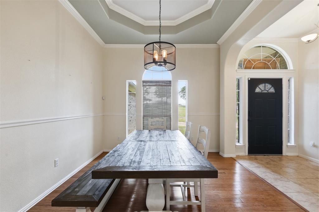4417 Slayton Road Cleburne, TX 76031 - Photo 13 of 28 Entryway with an arched transom window above a dark-paneled door
