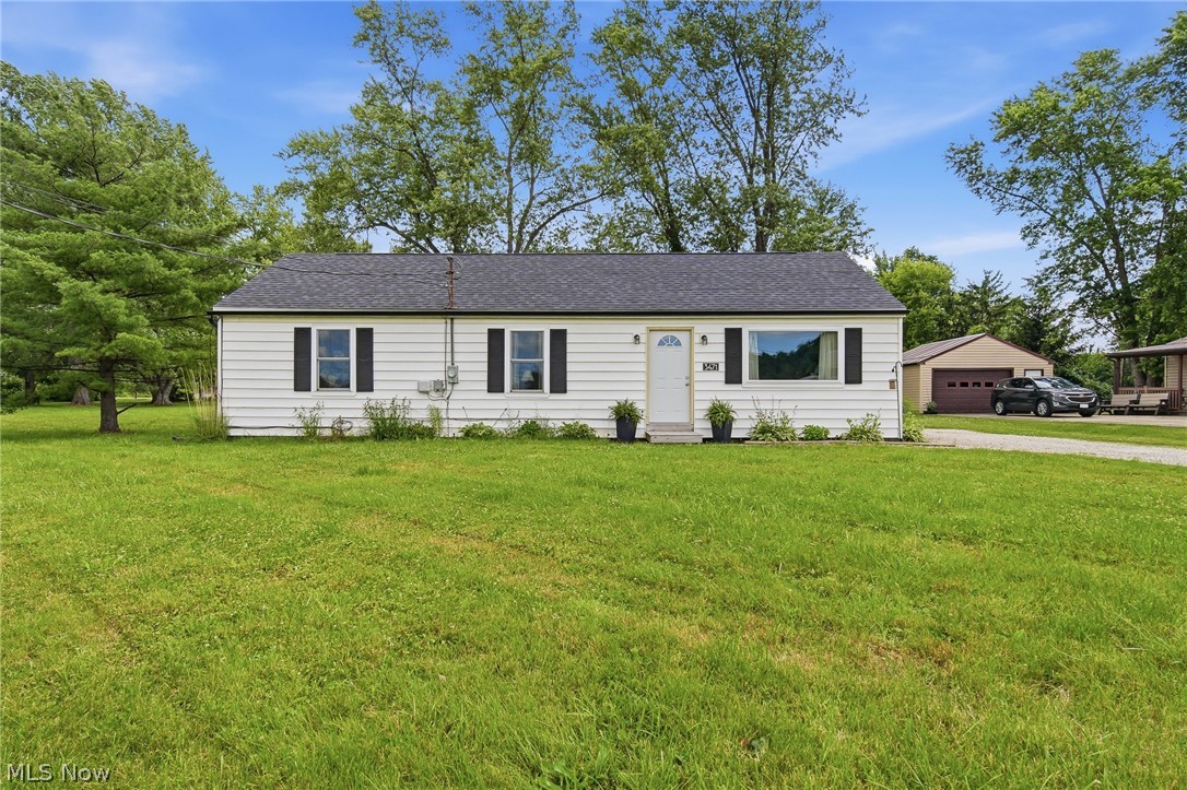 3471 State Rte 5 Newton Falls, OH 44444 - Photo 27 of 31 White siding home with black shutters, a dark shingle roof, and a prominent front door