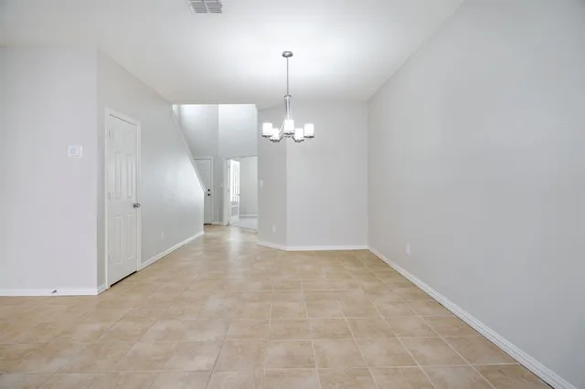 a view of a chandelier in big room and chandelier
