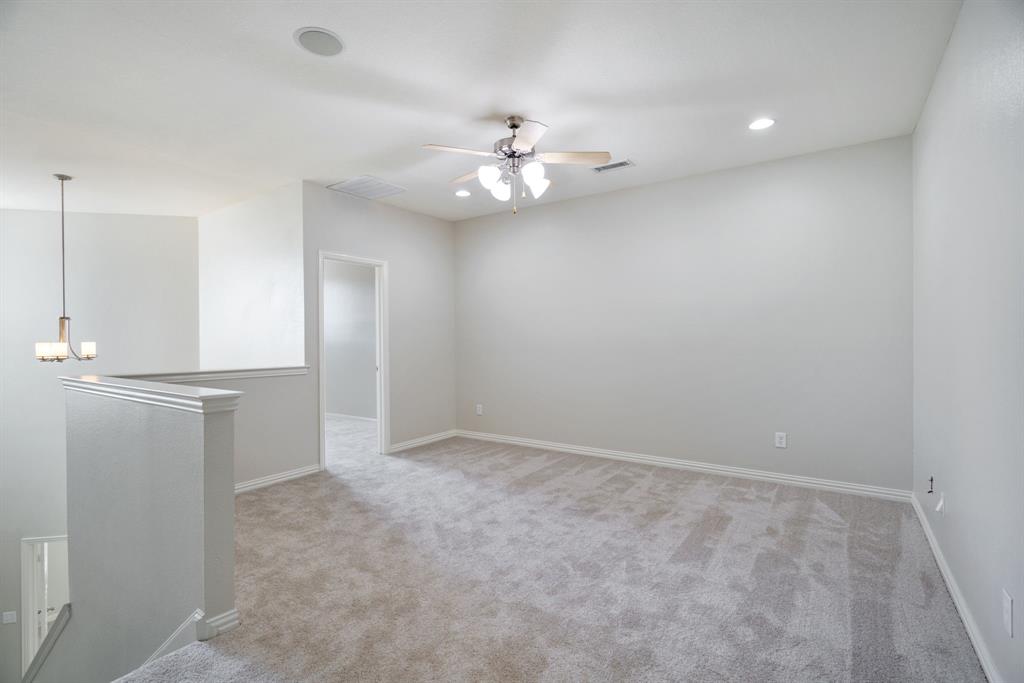 6407 Capulet Place Dallas, TX 75252 - Photo 18 of 33 an empty room with a ceiling fan and a window
