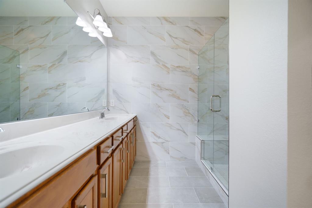 6407 Capulet Place Dallas, TX 75252 - Photo 25 of 33 a bathroom with a bathtub shower and a sink