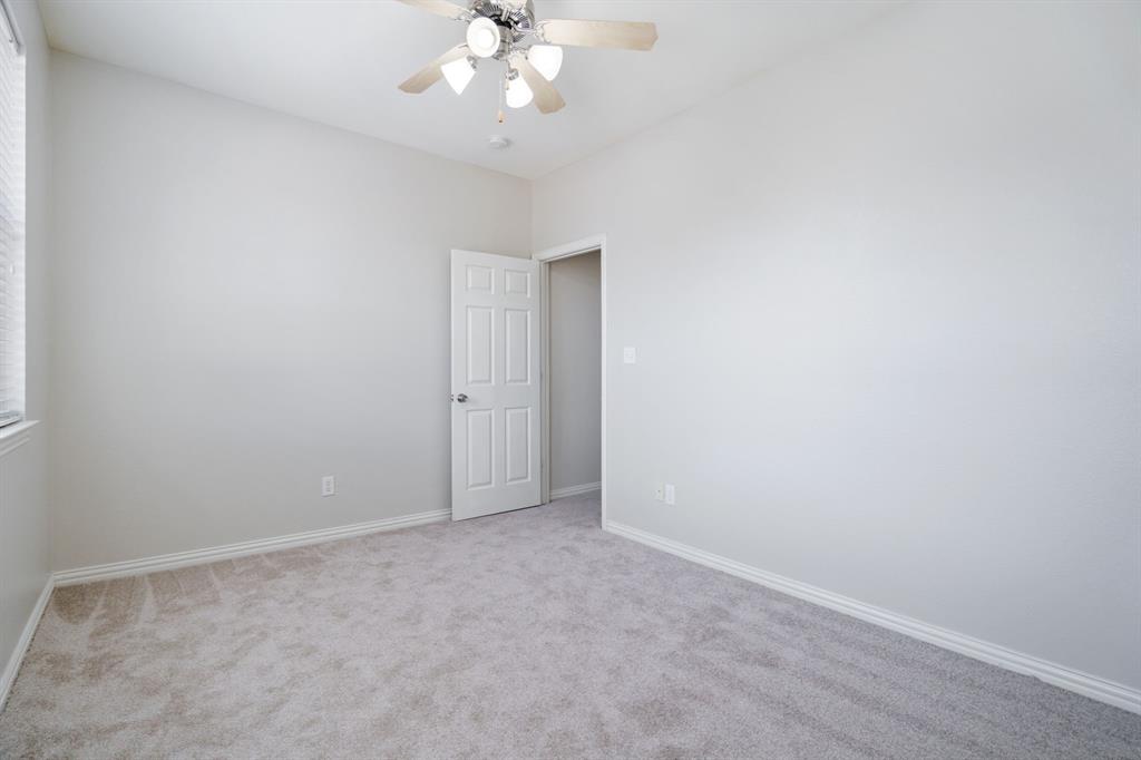 6407 Capulet Place Dallas, TX 75252 - Photo 32 of 33 an empty room with a chandelier fan