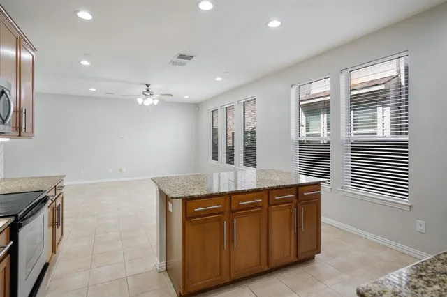 a kitchen with granite countertop a sink and a stove