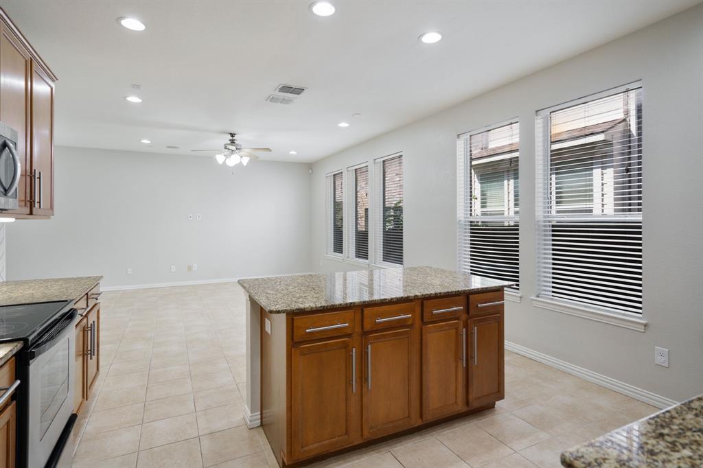 6407 Capulet Place Dallas, TX 75252 - Photo 6 of 33 a kitchen with granite countertop a sink and a stove