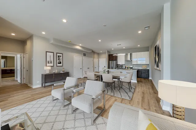 a living room with lots of furniture and kitchen view