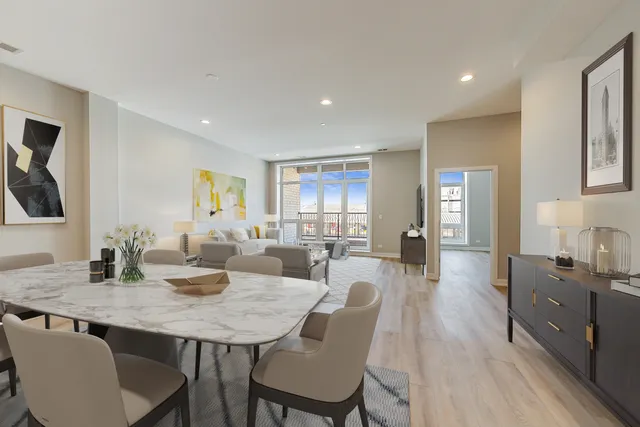 a view of a a dining room with furniture window and wooden floor