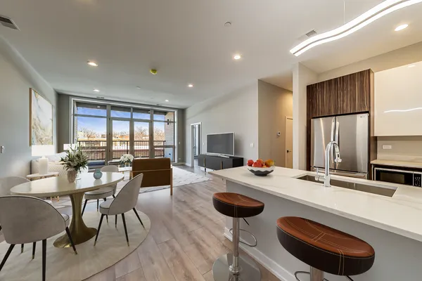 a kitchen with a dining table and chairs