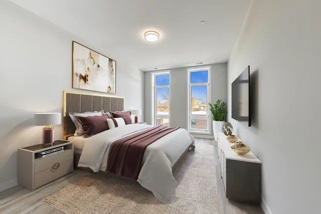 a bedroom with bed and flat screen tv