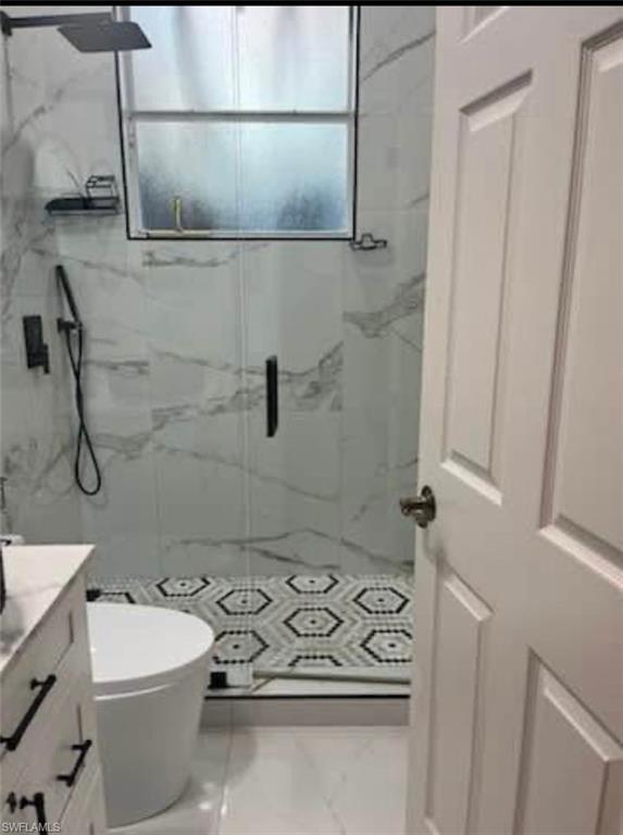 2841 12th Avenue Northeast Naples, FL 34120 - Photo 2 of 9 Bathroom featuring vanity and a marble finish shower
