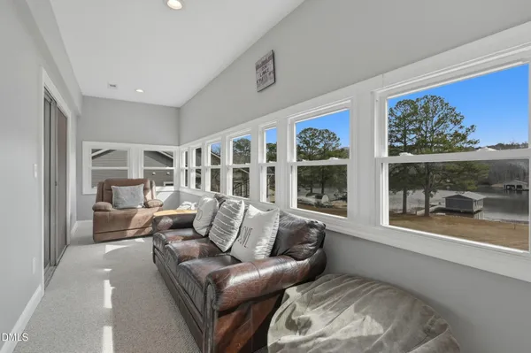 a living room with furniture and large window with outer view