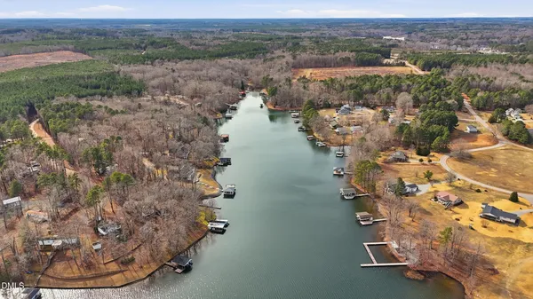 an aerial view of a house with a yard lake and mountain view