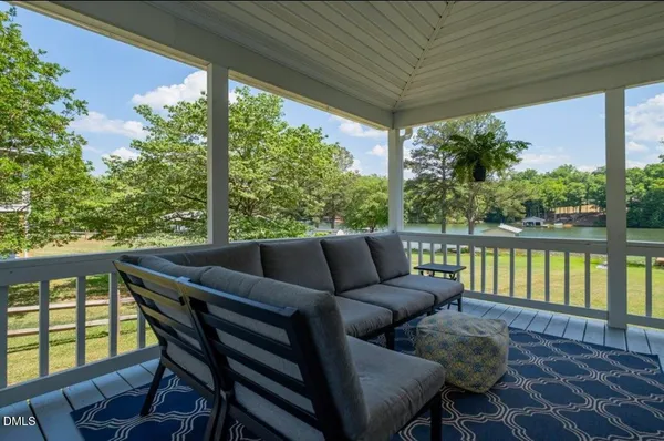 a balcony with furniture and wooden floor
