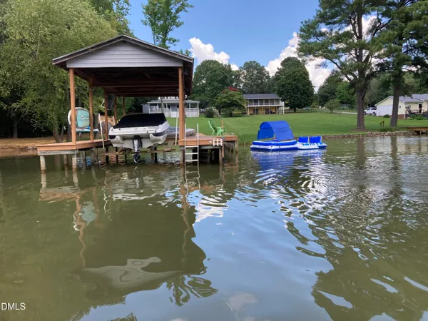 a view of a lake with a yard table and chairs