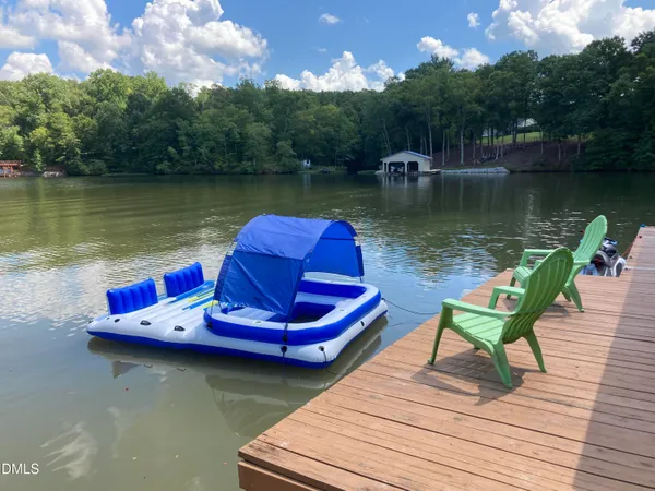 a view of a lake with lawn chairs