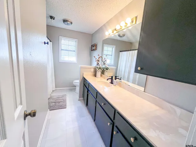 a large bathroom with a double vanity sink and a mirror