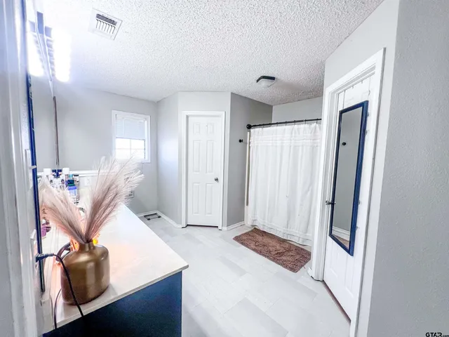 a view of a hallway to a livingroom and a hallway