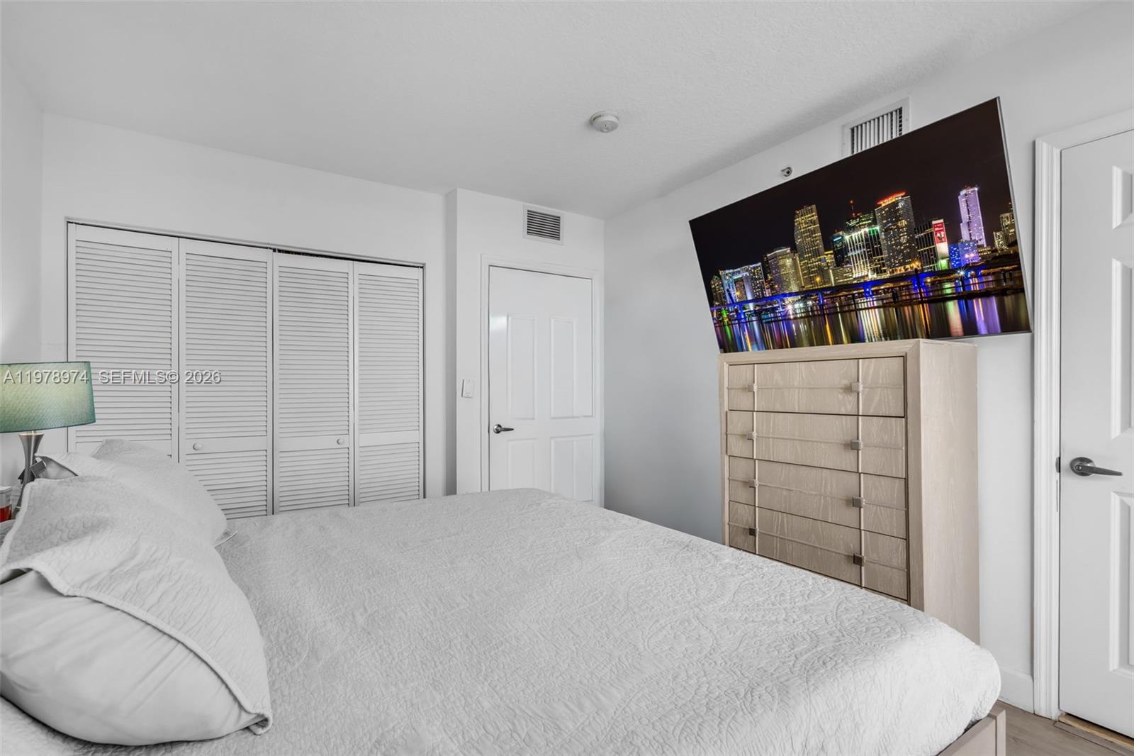 900 Southwest 8th Street, Unit 1603 Miami, FL 33130 - Photo 13 of 32 a bedroom with a bed and a walk in closet