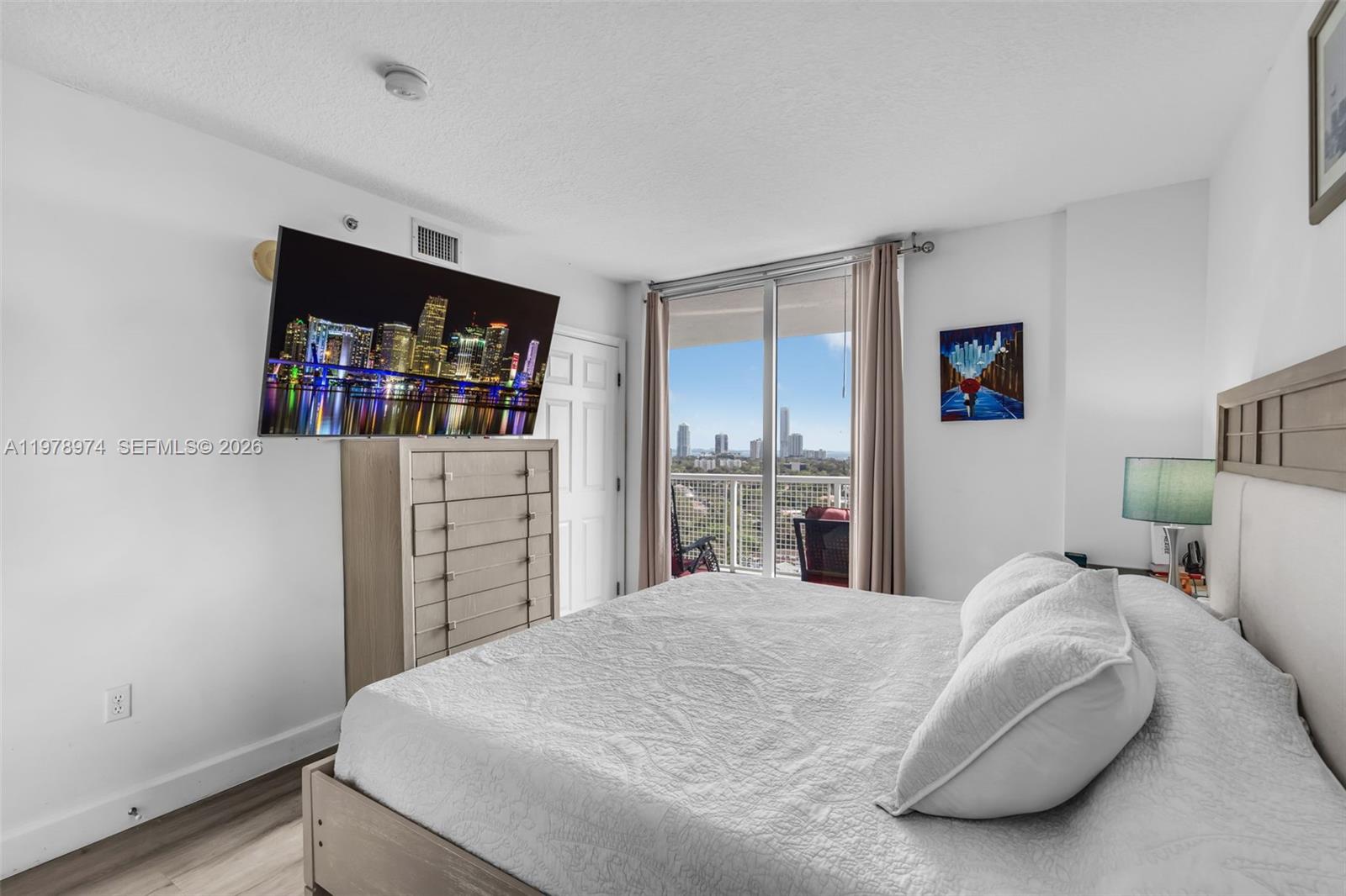 900 Southwest 8th Street, Unit 1603 Miami, FL 33130 - Photo 14 of 32 a bed room with a bed and a television