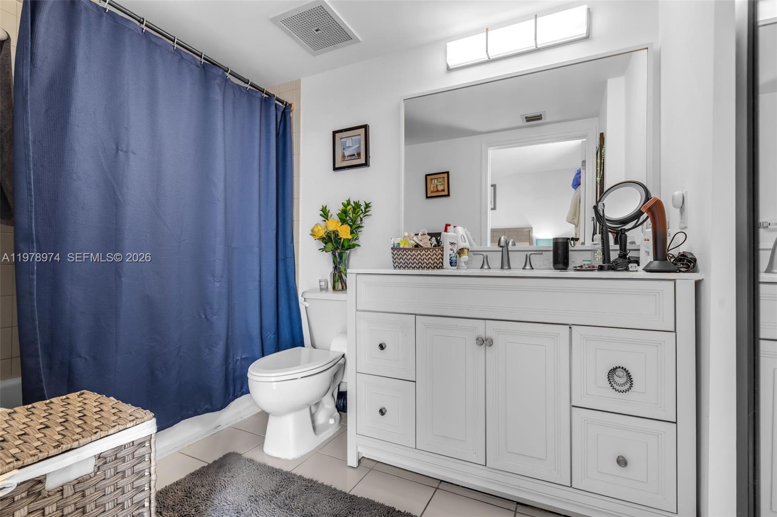 900 Southwest 8th Street, Unit 1603 Miami, FL 33130 - Photo 15 of 32 a bathroom with a sink a toilet and mirror
