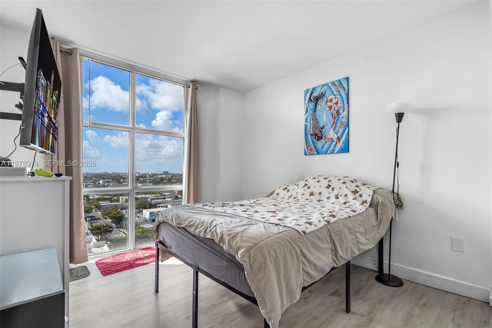 900 Southwest 8th Street, Unit 1603 Miami, FL 33130 - Photo 17 of 32 a bedroom with a bed and a large window