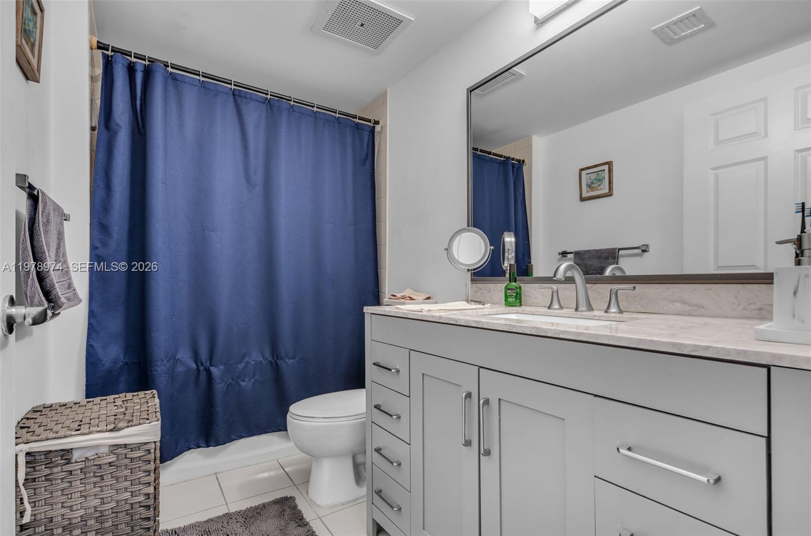 900 Southwest 8th Street, Unit 1603 Miami, FL 33130 - Photo 18 of 32 a bathroom with a granite countertop sink toilet and shower