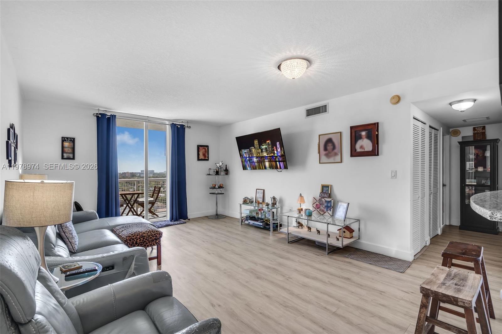 900 Southwest 8th Street, Unit 1603 Miami, FL 33130 - Photo 8 of 32 a living room with furniture and a flat screen tv