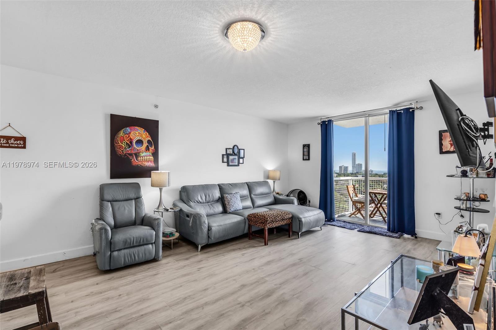 900 Southwest 8th Street, Unit 1603 Miami, FL 33130 - Photo 9 of 32 a living room with furniture and a wooden floor