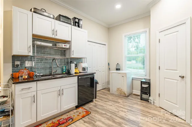 a kitchen with granite countertop a sink and cabinets