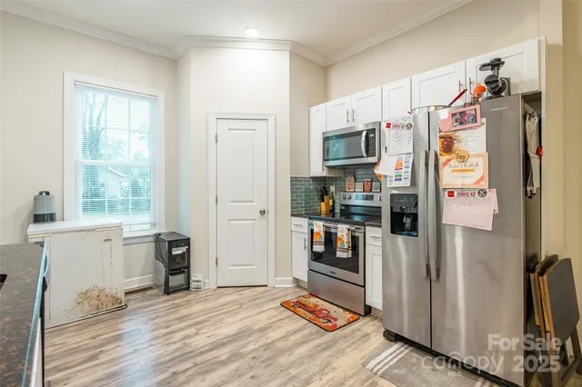 a kitchen with stainless steel appliances a refrigerator stove and sink