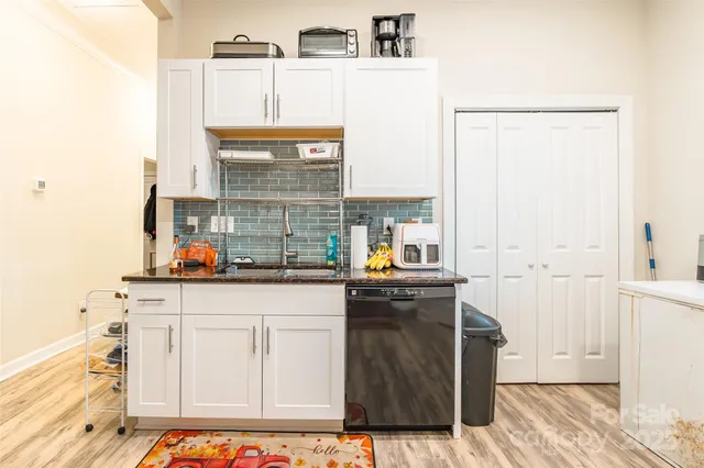 a kitchen with stainless steel appliances a sink and cabinets