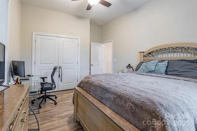 a bedroom with a bed a desk and chair