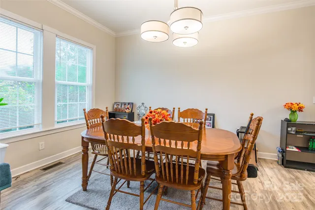 a view of a dining room with furniture window and wooden floor