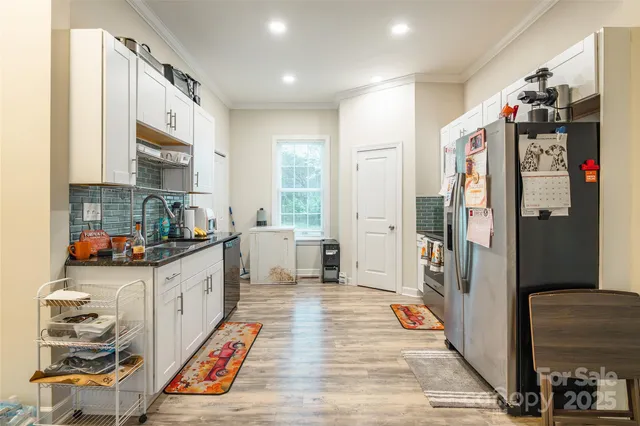 a kitchen with stainless steel appliances granite countertop a refrigerator and a stove