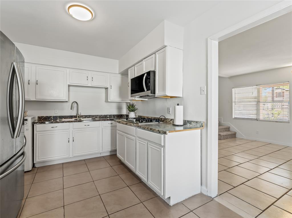 826 Ryan Road Dallas, TX 75224 - Photo 15 of 34 a kitchen with a stove top oven sink and cabinets